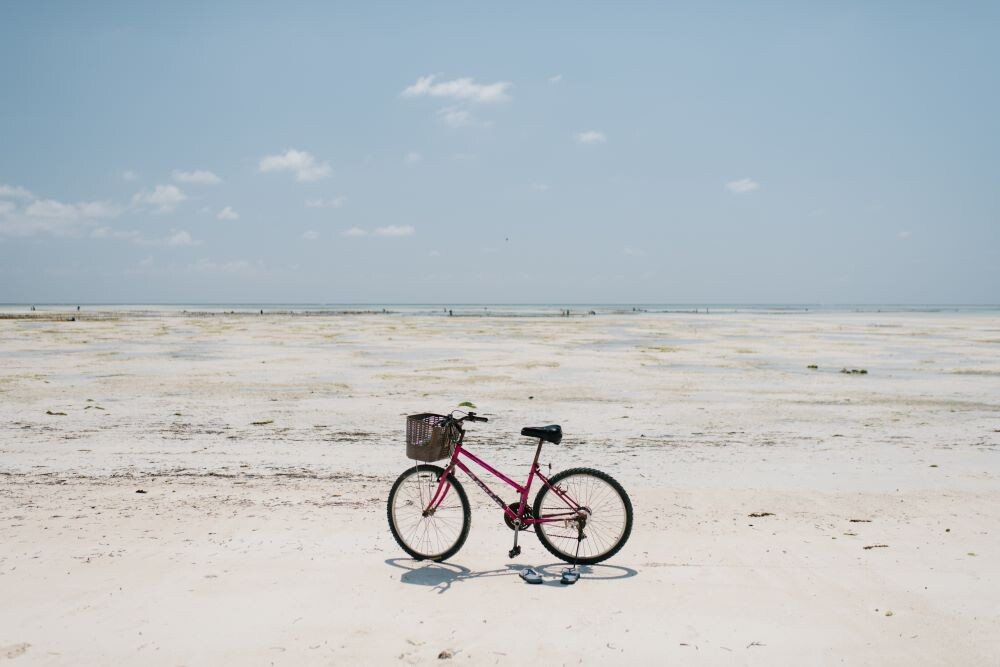 bike standing alone on white sandy beach