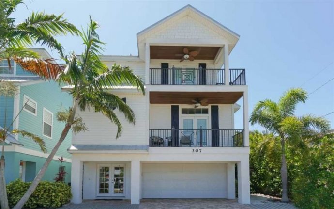Exterior of multilevel home with garage in Anna Maria Island 