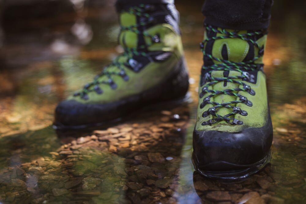 hoking boots standing in clear water
