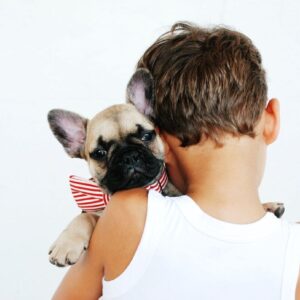 little kid holding dog