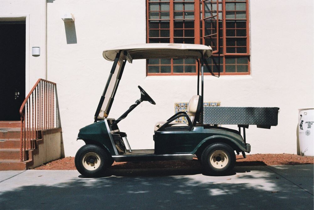 golf cart in front of white building